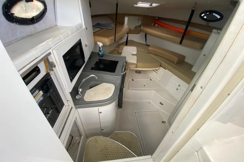 Slide: The Image of 2002 Wellcraft 290 Coastal cabin interior with kitchenette and seating area. - 30