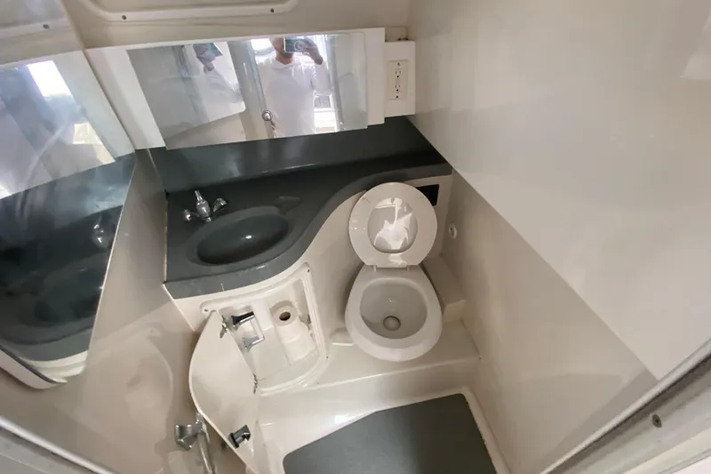Slide: The Image of 2002 Wellcraft 290 Coastal boat bathroom with sink, toilet, and mirror. - 33