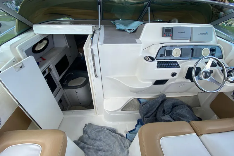 Slide: The Image of 2002 Wellcraft 290 Coastal boat interior with helm, steering wheel, and cabin entrance. - 35