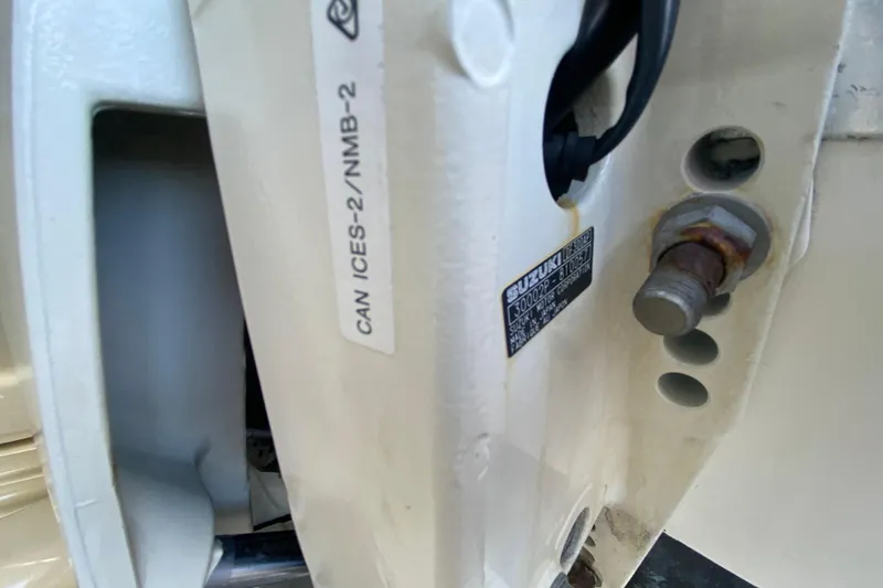 Slide: The Image of Close-up of a 2002 Wellcraft 290 Coastal boat engine component with Suzuki label. - 41