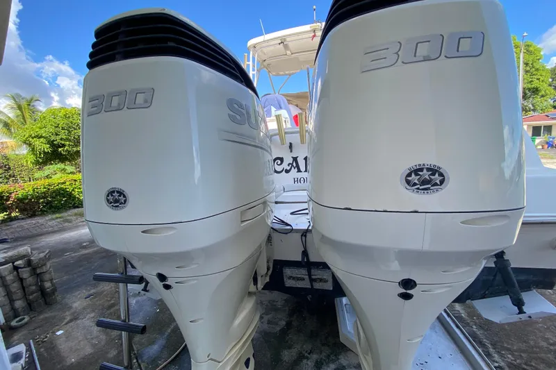 Slide: The Image of 2002 Wellcraft 290 Coastal boat with twin 300 horsepower engines, docked outdoors. - 42