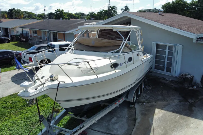 Slide: The Image of 2002 Wellcraft 290 Coastal boat on trailer in residential driveway. - 5