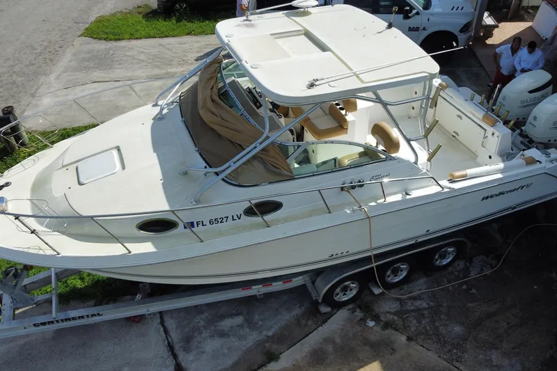 Slide: The Image of 2002 Wellcraft 290 Coastal boat on trailer, aerial view, parked near driveway. - 9