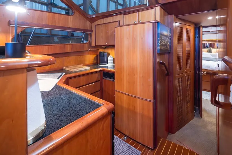 Slide: The Image of Luxurious 2004 Mikelson 50 Sportfisher yacht interior with wood cabinetry and modern amenities. - 12