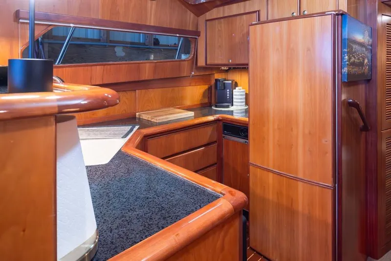 Slide: The Image of Luxurious wooden kitchen interior of 2004 Mikelson 50 Sportfisher yacht. - 13