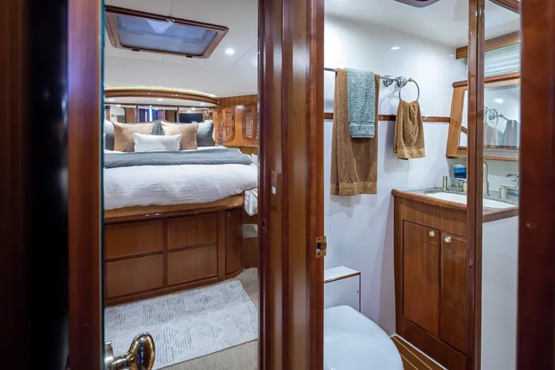 Slide: The Image of Luxurious interior of 2004 Mikelson 50 Sportfisher yacht with cozy bedroom and bathroom. - 22