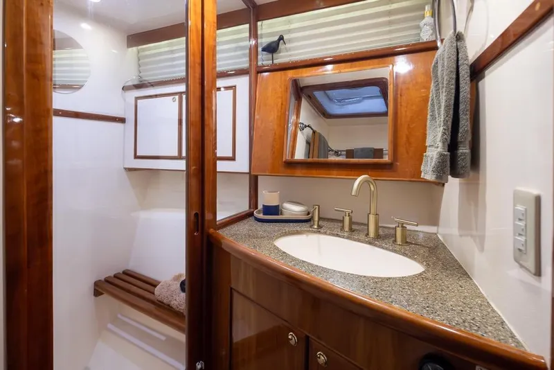 Slide: The Image of Luxurious bathroom in 2004 Mikelson 50 Sportfisher yacht with wood accents and modern fixtures. - 27
