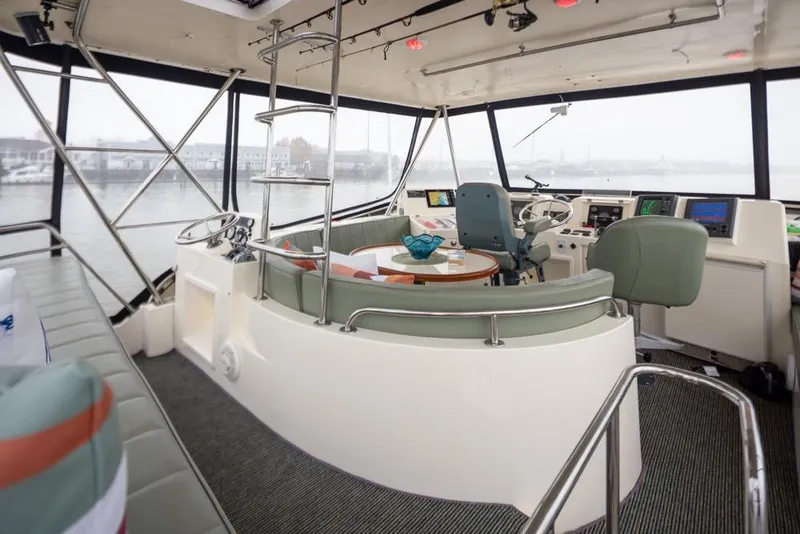 Slide: The Image of Interior of 2004 Mikelson 50 Sportfisher yacht with helm and seating area. - 28