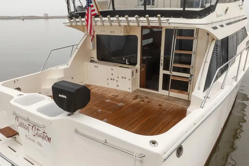 Slide: The Image of 2004 Mikelson 50 Sportfisher yacht with teak deck and American flag. - 3