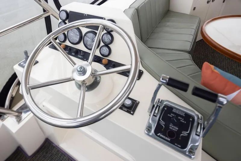 Slide: The Image of Steering wheel and controls of a 2004 Mikelson 50 Sportfisher yacht interior. - 30