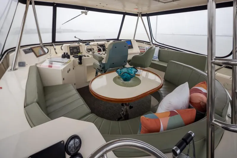 Slide: The Image of 2004 Mikelson 50 Sportfisher yacht interior with helm, seating, and table. - 32