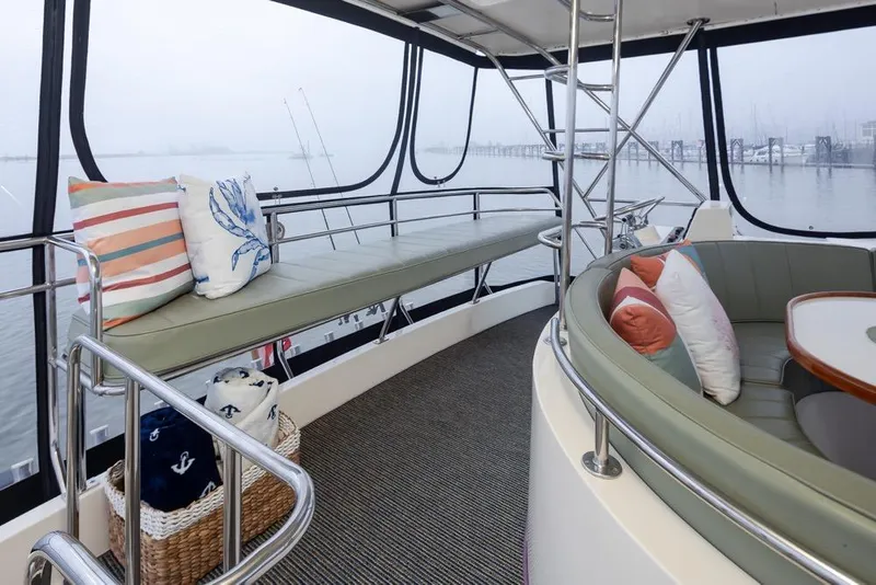 Slide: The Image of Interior of 2004 Mikelson 50 Sportfisher yacht with cushioned seating and decorative pillows. - 36