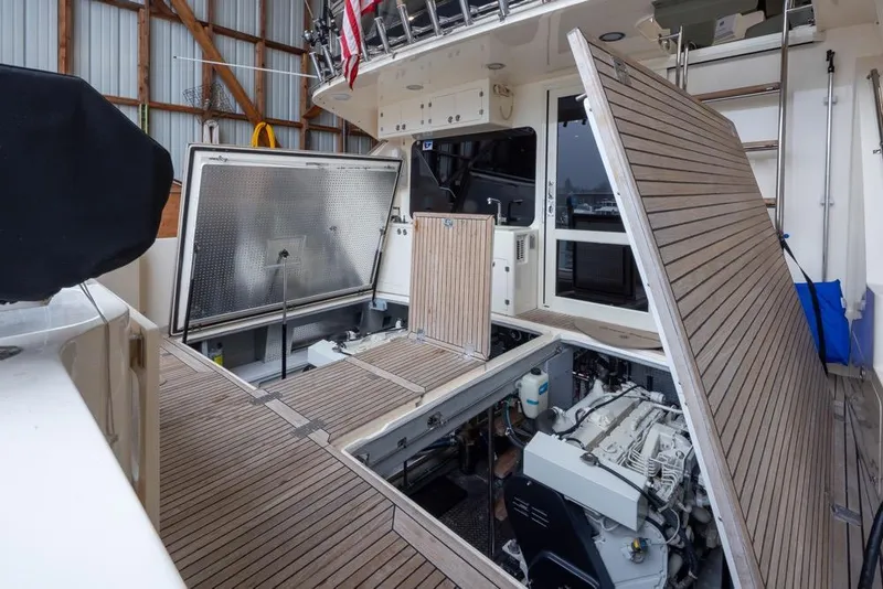 Slide: The Image of 2004 Mikelson 50 Sportfisher yacht engine compartment with open hatches in a marina. - 43
