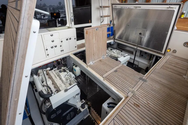 Slide: The Image of Engine room of a 2004 Mikelson 50 Sportfisher yacht with open hatches. - 44