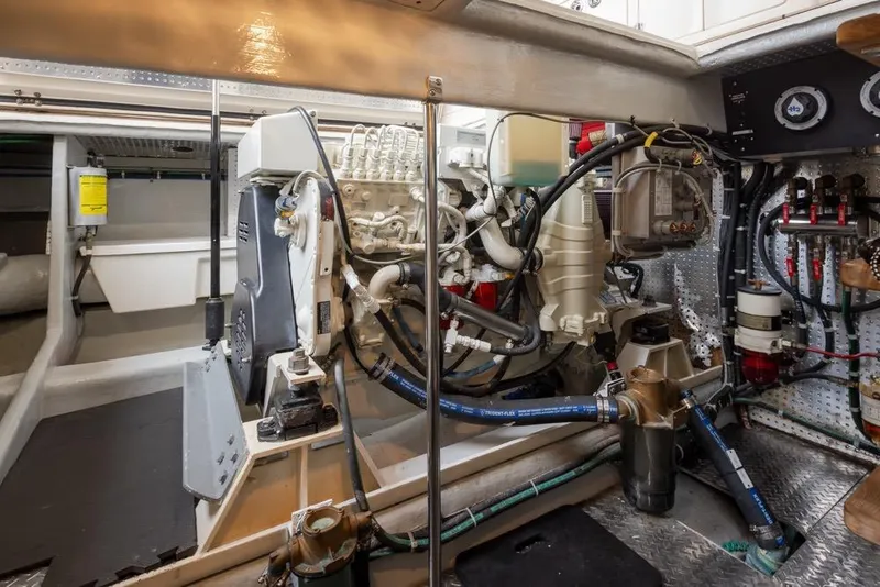 Slide: The Image of Engine room of 2004 Mikelson 50 Sportfisher with complex machinery and wiring. - 47