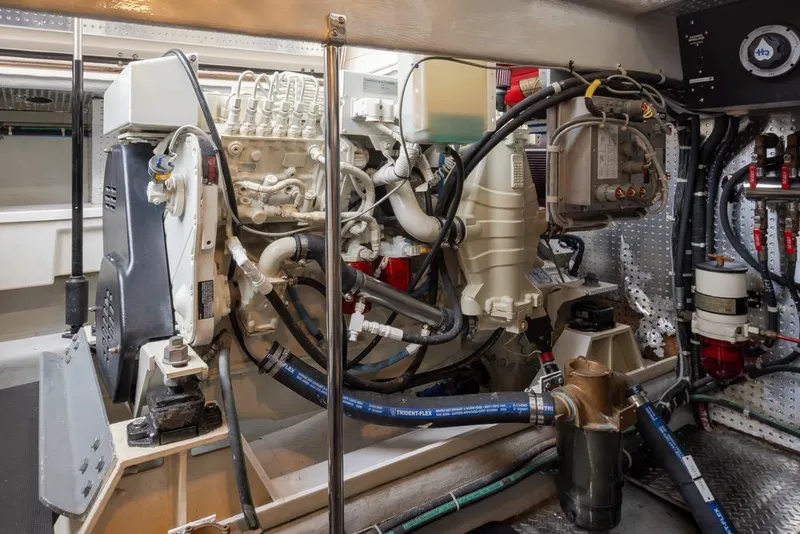 Slide: The Image of Engine room of a 2004 Mikelson 50 Sportfisher, showcasing complex machinery and components. - 48