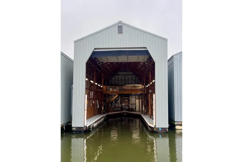 Slide: The Image of Boat in covered dock, Mikelson 50 Sportfisher 2004, sheltered marina setting. - 53