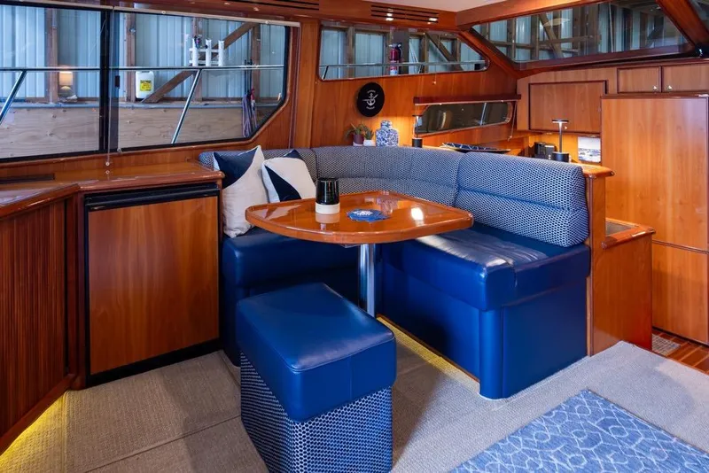 Slide: The Image of Luxurious interior of 2004 Mikelson 50 Sportfisher yacht with elegant seating and wooden finishes. - 9