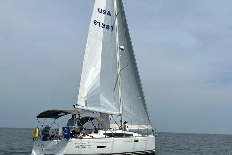 Slide: The Image of 2014 Jeanneau 379 sailboat on open water, USA sail number 61381. - 0