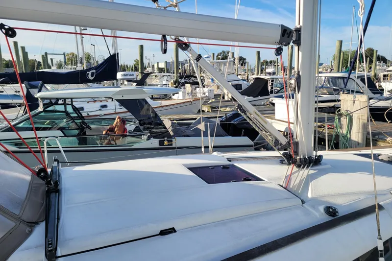 Slide: The Image of 2014 Jeanneau 379 sailboat docked at a marina with other boats. - 12