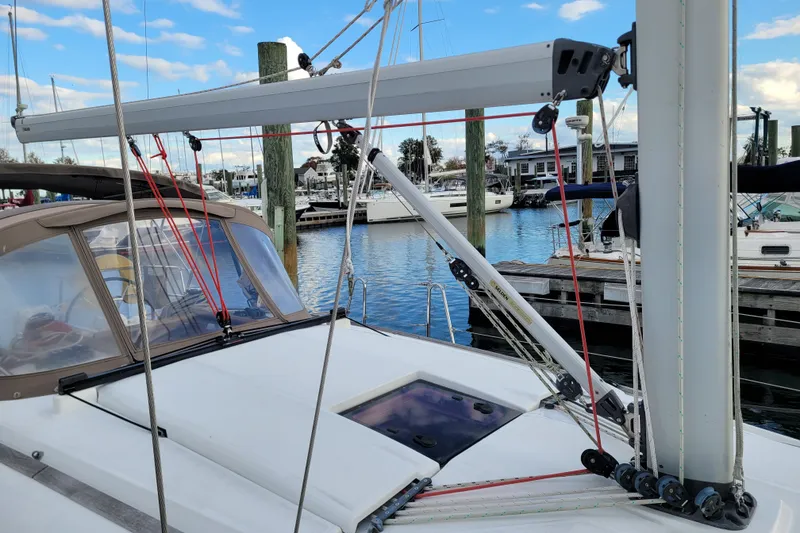 Slide: The Image of 2014 Jeanneau 379 sailboat deck with rigging, docked at marina under blue sky. - 13