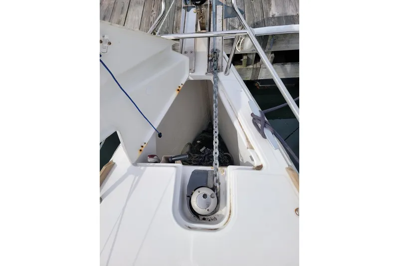 Slide: The Image of Anchor chain compartment on 2014 Jeanneau 379 sailboat, docked at a wooden pier. - 17