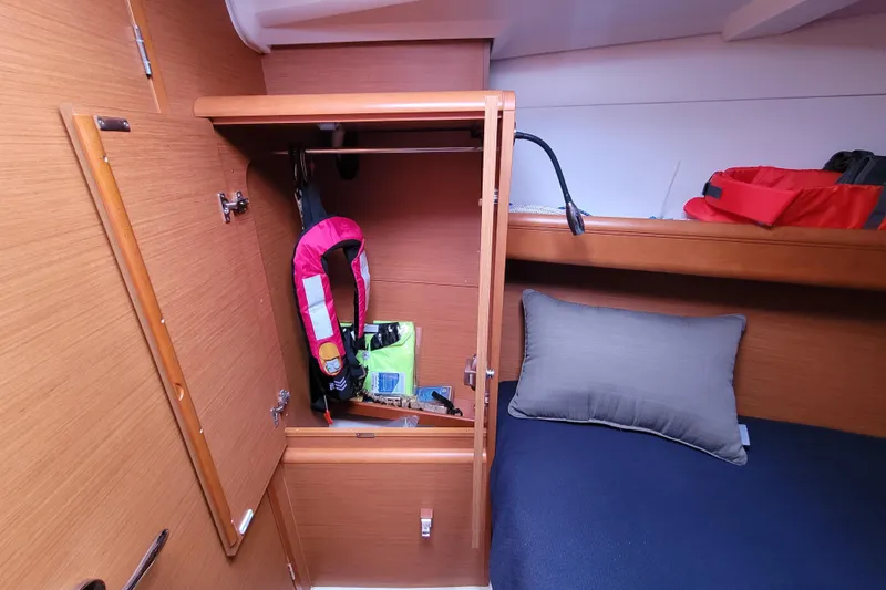 Slide: The Image of Interior cabin of 2014 Jeanneau 379 sailboat with open closet and life jacket. - 27