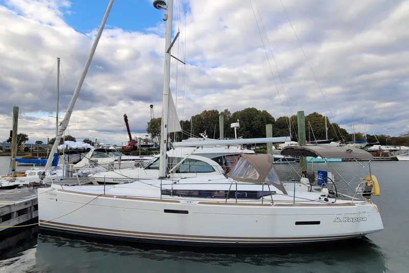 Slide: The Image of 2014 Jeanneau 379 sailboat docked at marina under cloudy sky. - 3