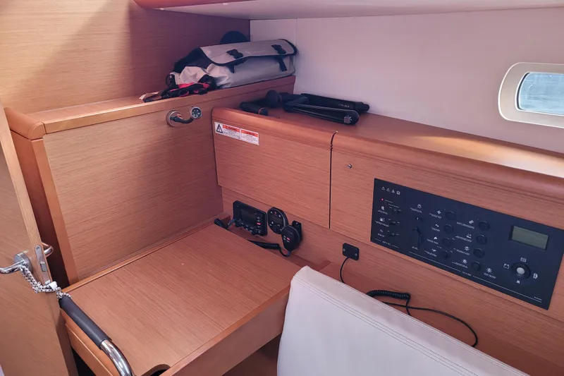 Slide: The Image of Interior of 2014 Jeanneau 379 sailboat with navigation panel and storage area. - 33