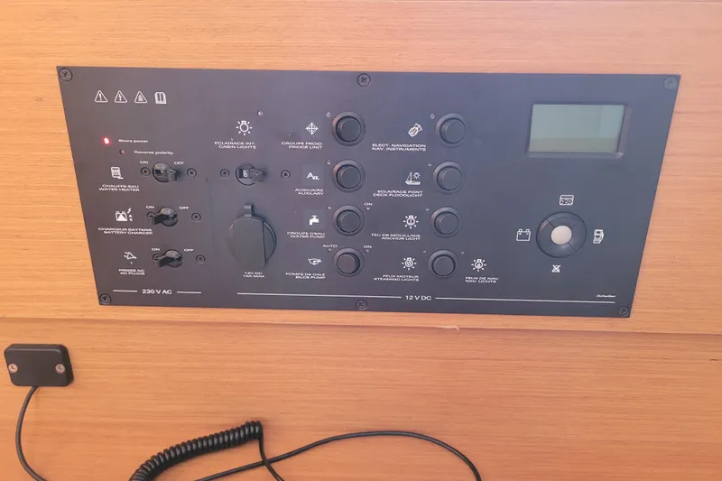 Slide: The Image of Control panel of a 2014 Jeanneau 379 sailboat, featuring various switches and indicators. - 36