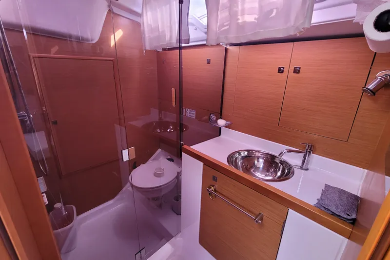 Slide: The Image of Luxurious bathroom in 2014 Jeanneau 379 yacht with modern fixtures and wood accents. - 40