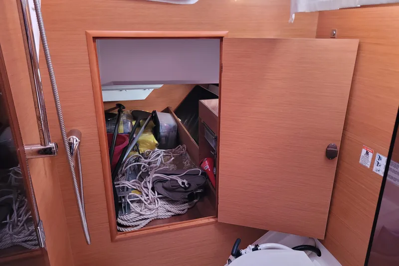 Slide: The Image of Storage compartment on a 2014 Jeanneau 379 sailboat, containing ropes and boating equipment. - 46