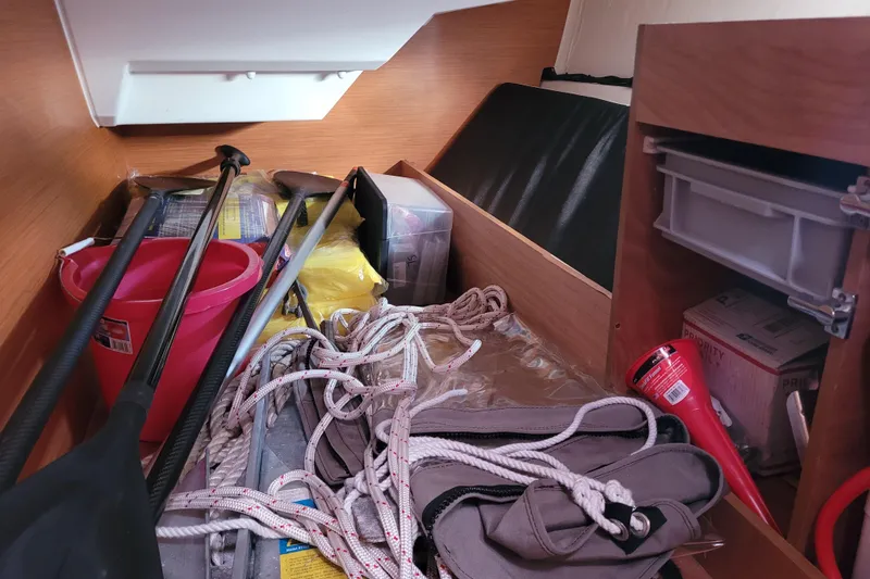 Slide: The Image of Storage area in a 2014 Jeanneau 379 sailboat with ropes, paddles, and supplies. - 47