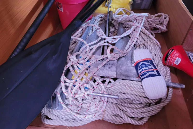 Slide: The Image of Boat storage with ropes, anchor, paddle, and flashlight on Jeanneau 379, 2014 model. - 48