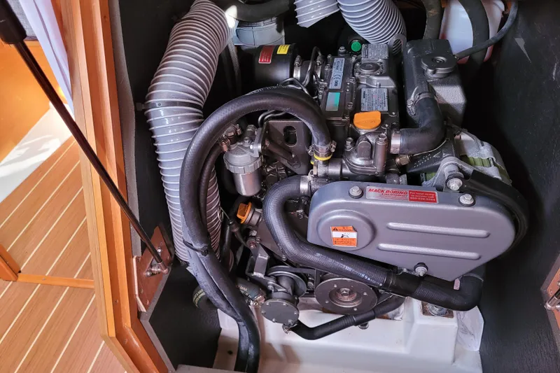 Slide: The Image of Engine compartment of a 2014 Jeanneau 379 sailboat, showcasing mechanical components. - 53