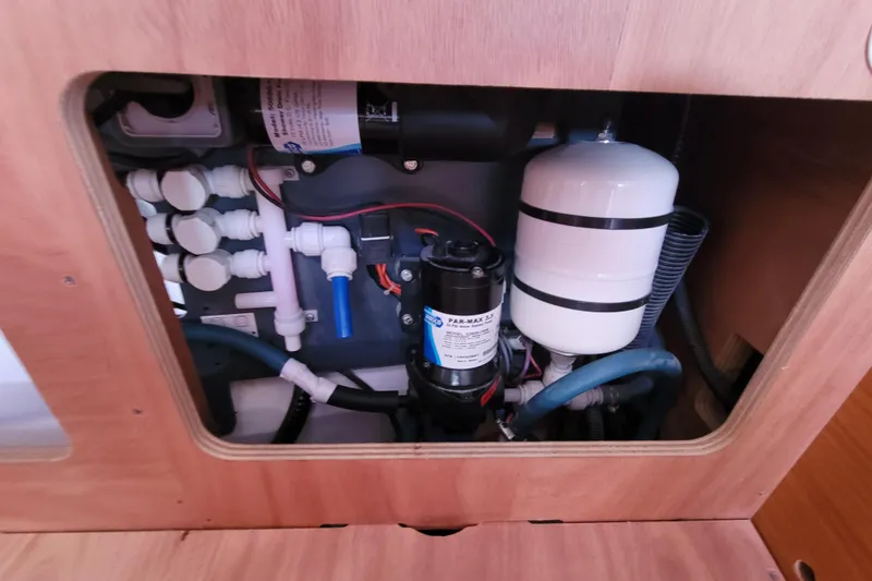 Slide: The Image of 2014 Jeanneau 379 yacht plumbing system with pump and pipes visible. - 57