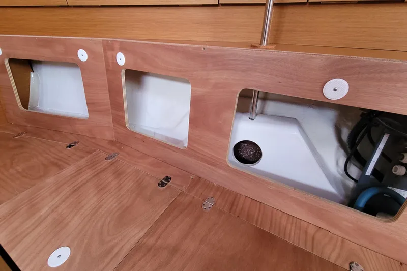 Slide: The Image of Interior view of 2014 Jeanneau 379 sailboat, showcasing wooden storage compartments. - 62