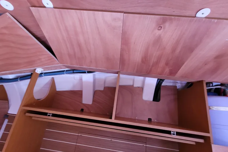 Slide: The Image of Interior view of 2014 Jeanneau 379 sailboat with wooden cabinetry and storage compartments. - 65