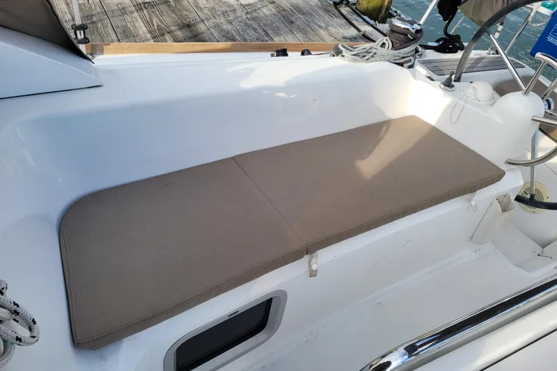 Slide: The Image of Cockpit seating area on a 2014 Jeanneau 379 sailboat with beige cushion. - 10