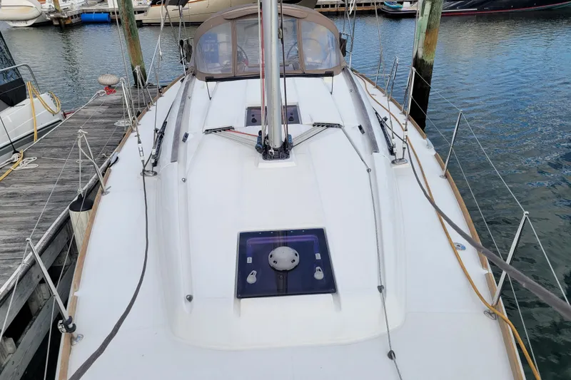 Slide: The Image of 2014 Jeanneau 379 sailboat docked at marina, showcasing deck and rigging. - 14