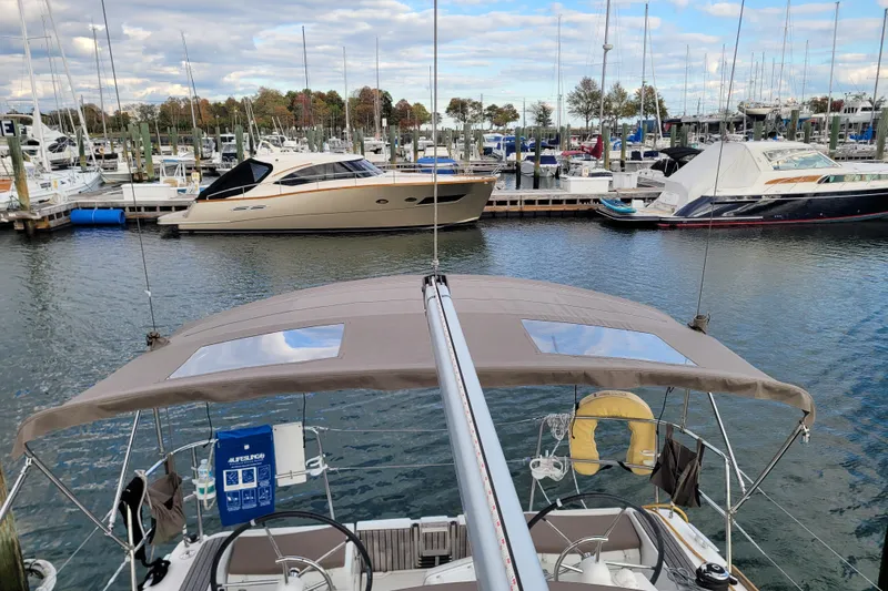 Slide: The Image of 2014 Jeanneau 379 sailboat docked in a marina with other boats. - 19