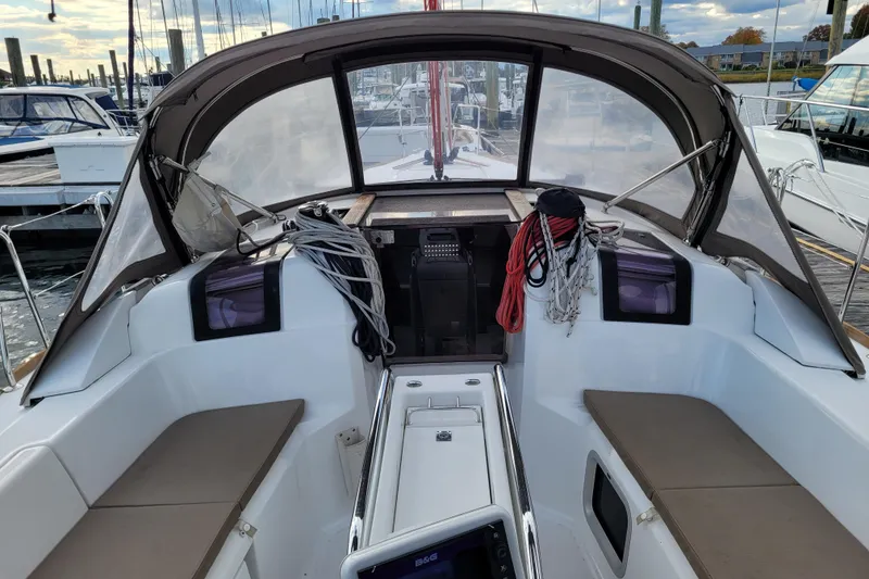 Slide: The Image of 2014 Jeanneau 379 sailboat cockpit with seating, ropes, and canopy in marina setting. - 20