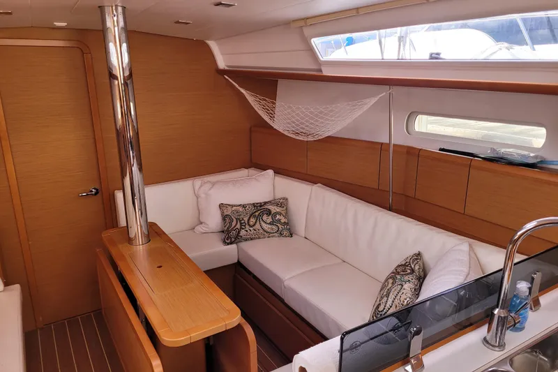 Slide: The Image of Interior of 2014 Jeanneau 379 sailboat with cozy seating and elegant wood finish. - 23