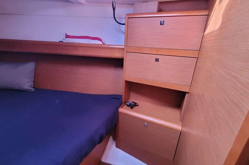 Slide: The Image of 2014 Jeanneau 379 interior cabin with wooden storage and bed. - 25
