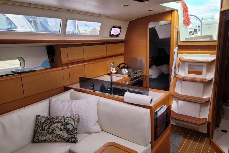 Slide: The Image of Interior of 2014 Jeanneau 379 sailboat with modern kitchen and cozy seating area. - 29