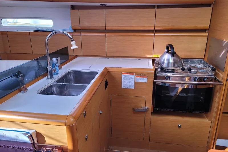 Slide: The Image of Modern kitchen in a 2014 Jeanneau 379 sailboat with sink, stove, and storage. - 37