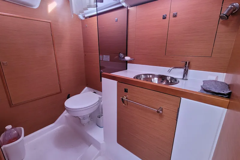 Slide: The Image of 2014 Jeanneau 379 yacht bathroom with wooden cabinetry, sink, and toilet. - 41