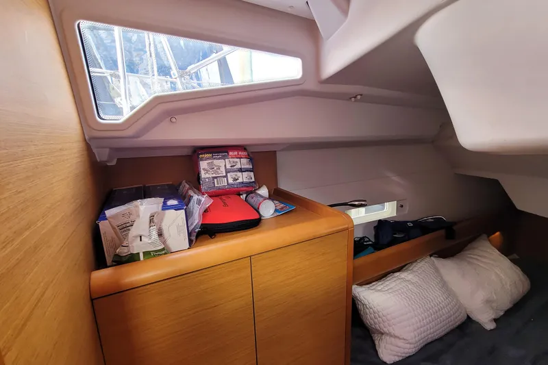Slide: The Image of Cozy cabin interior of 2014 Jeanneau 379 sailboat with storage and pillows. - 43