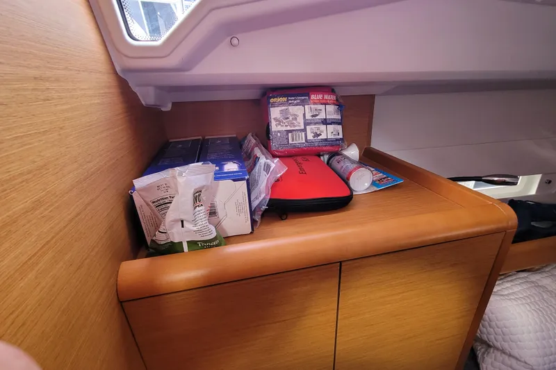 Slide: The Image of Storage area in a 2014 Jeanneau 379 yacht with emergency supplies and snacks. - 44