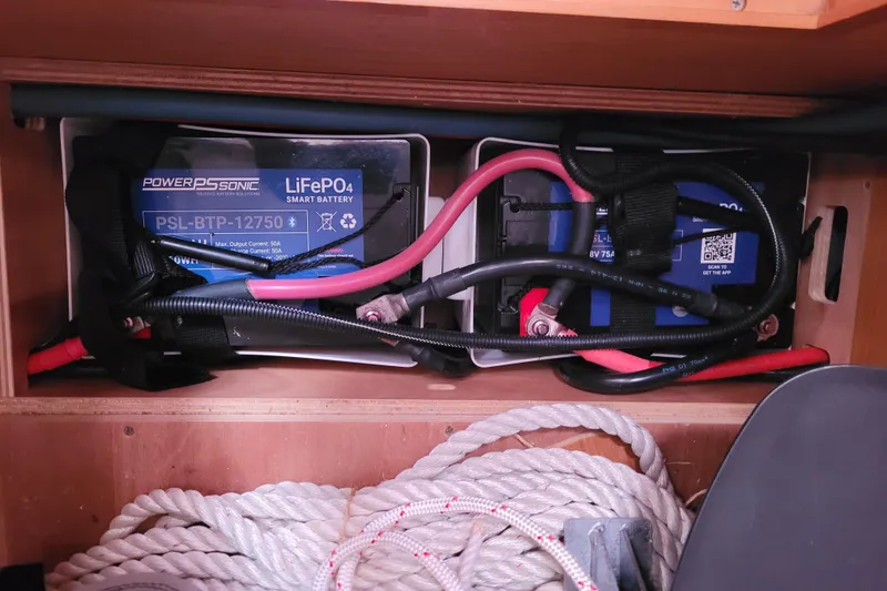Slide: The Image of 2014 Jeanneau 379 sailboat battery compartment with LiFePO4 batteries and coiled rope. - 50